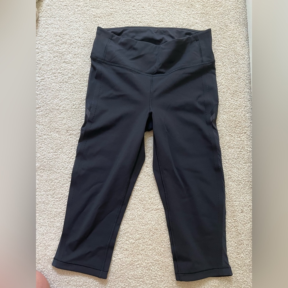 Lulu leggings. Hits below knee, sheer fabric running down both outside legs.